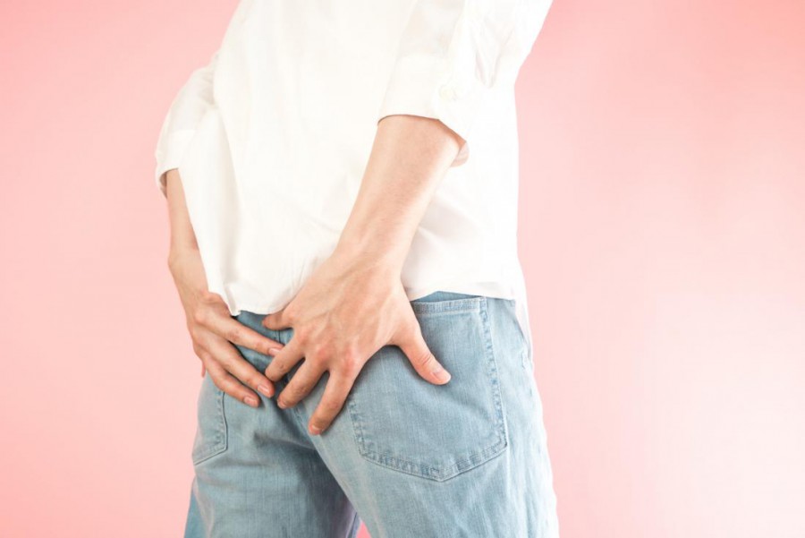 man-holding-his-tailbone